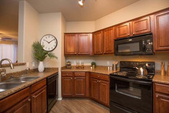 a kitchen with a large clock on the wall at The Pavilions by Picerne, Nevada