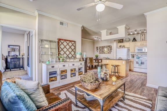 Interior living room, with white walls, hardwood flooring, wooden coffee table at Cypress Lake at Stonebriar Apartments, Frisco, TX, 75034