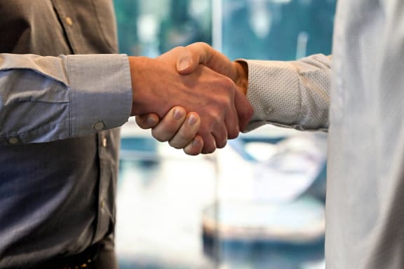 two men shaking hands with each other