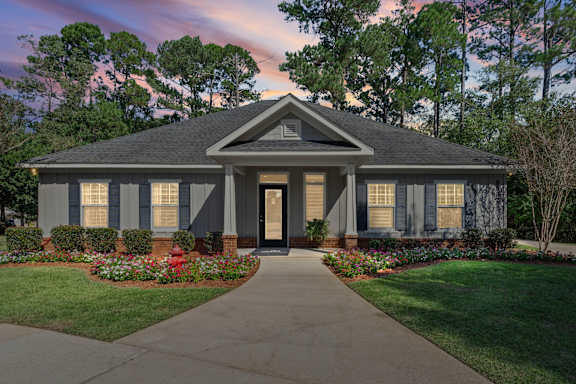 A house with a front yard and a driveway.