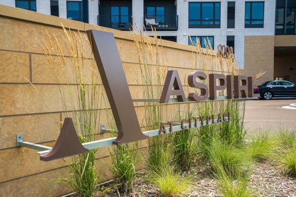 a sign in front of a building that says Aspire at CityPlace