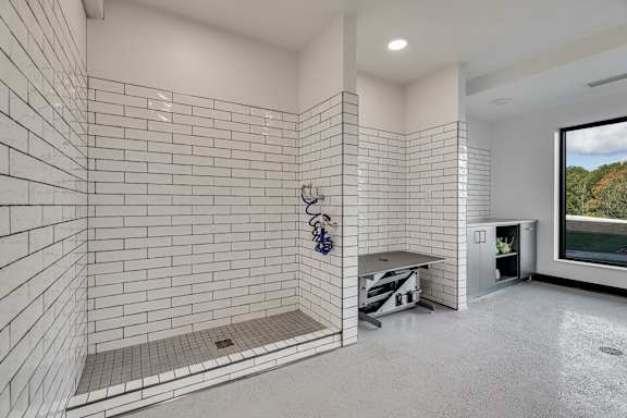 a large white tiled pet wash in a large room with a window