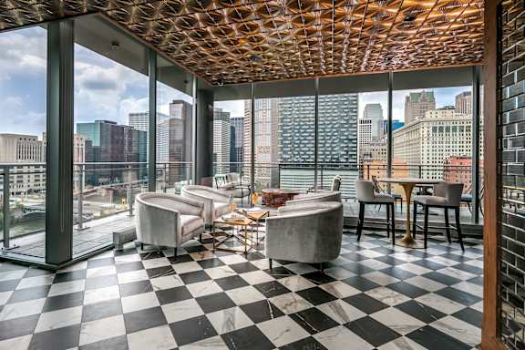 A black and white checkered floor in a room with a wooden ceiling.