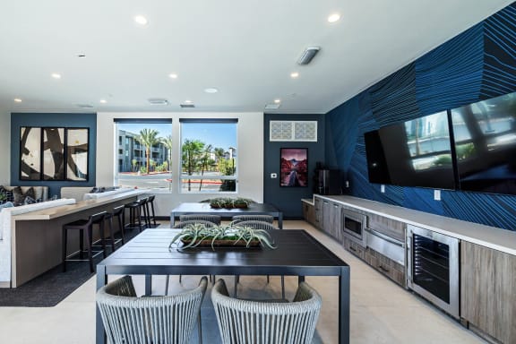 A modern kitchen with a dining table and chairs. at BASE APARTMENT HOMES, LAS VEGAS, NV