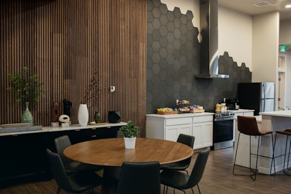 a kitchen and dining room with a table and chairs