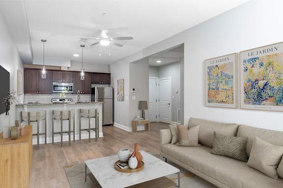 A living room with a couch, coffee table, and two paintings on the wall.
