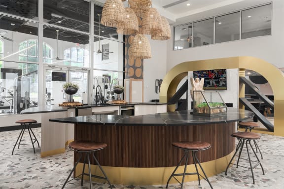 A modern bar with a black counter and stools. at The Heights Apartments, Cincinnati, 45220