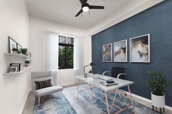 a home office with a blue accent wall and a white desk