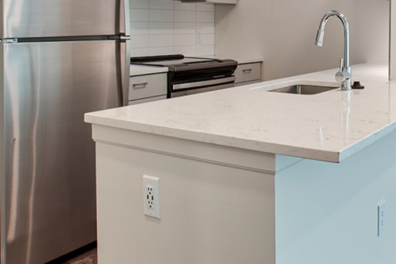 a kitchen island with a sink and stove in a 555 waverly unit