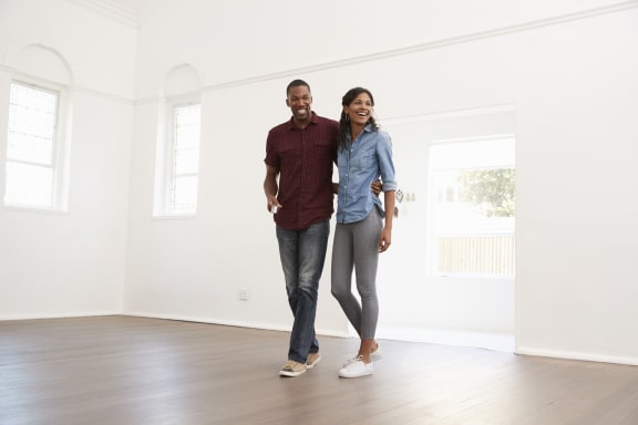a couple walking through an empty house