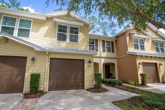 A two-story house with a garage on the first floor.