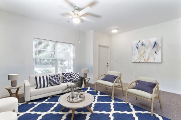 a living room with a couch and chairs