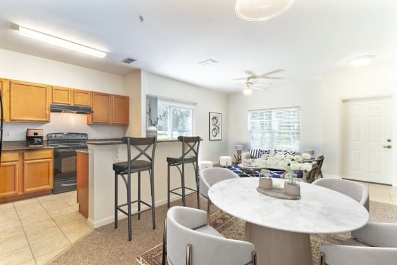 a living room with a kitchen and a dining table