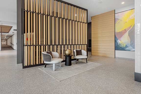 A room with a wooden partition and two chairs.