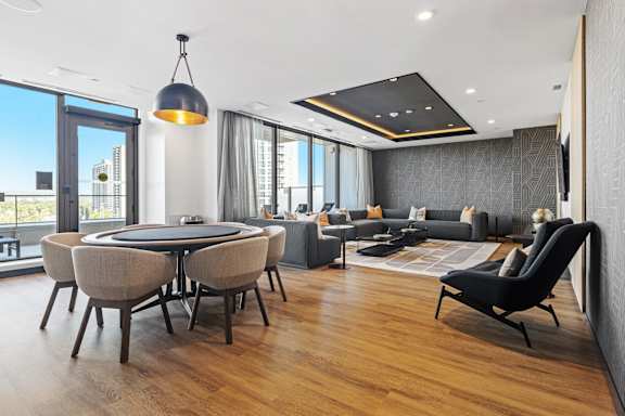 A modern living room with a large table and chairs.