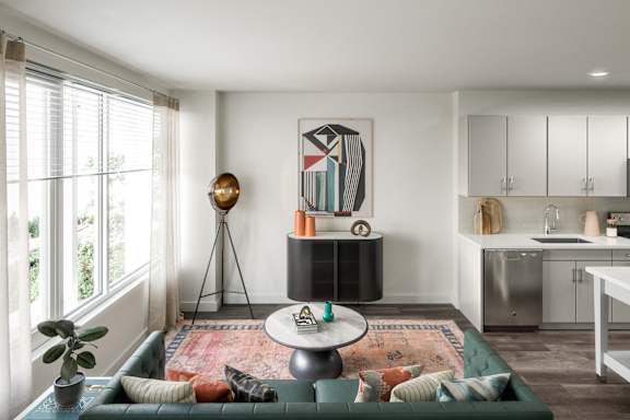a living room with a green couch and a table