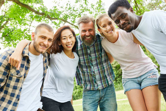 a group of friends posing for a photo in a park at BrookStone Village, Ohio 45209