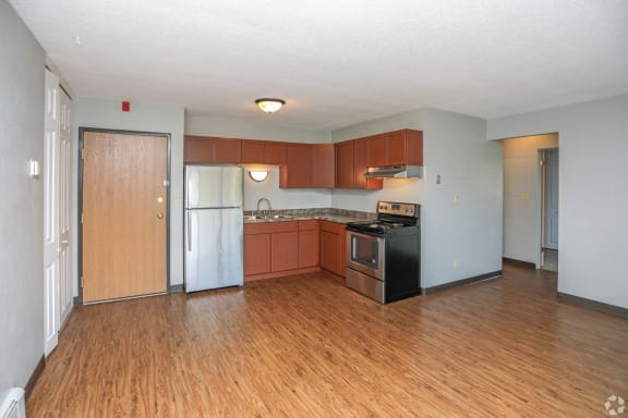 a kitchen with wood floors and white walls