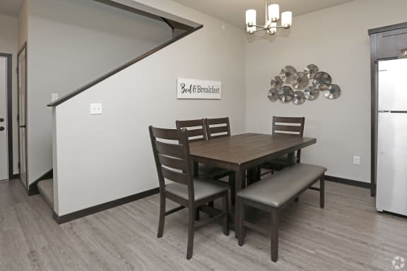 a dining area with a table and chairs