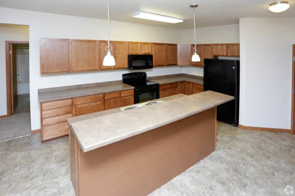an empty kitchen with a large island