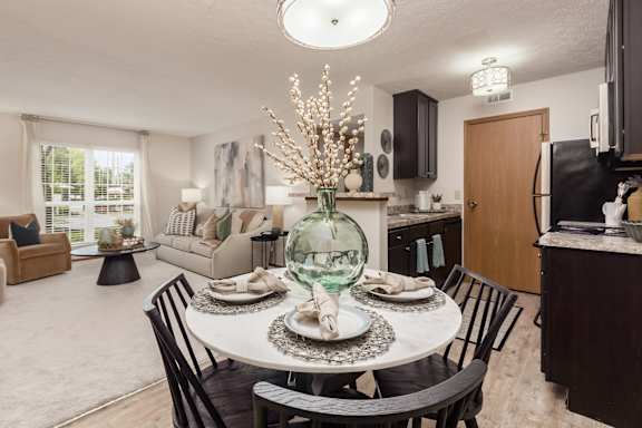 a kitchen and dining room with a table and chairs