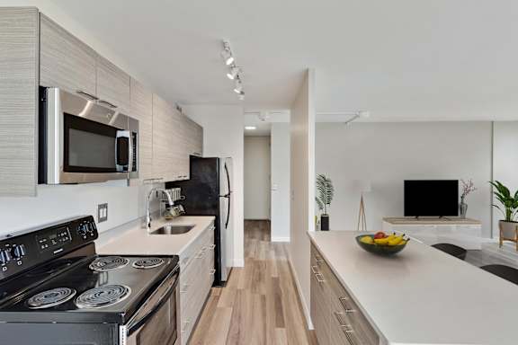 A modern kitchen with a stove top oven and microwave.