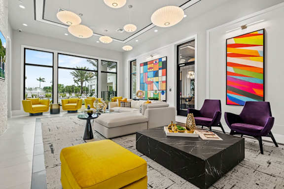 a living room with yellow furniture and large windows at Altis Grand Kendall, Florida