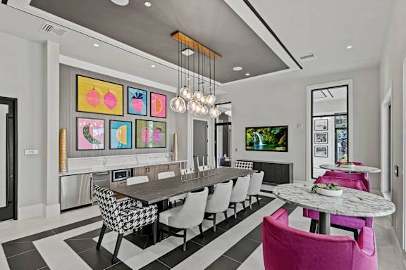 a dining room with a long table and chairs at Altis Grand Kendall, Florida, 33186