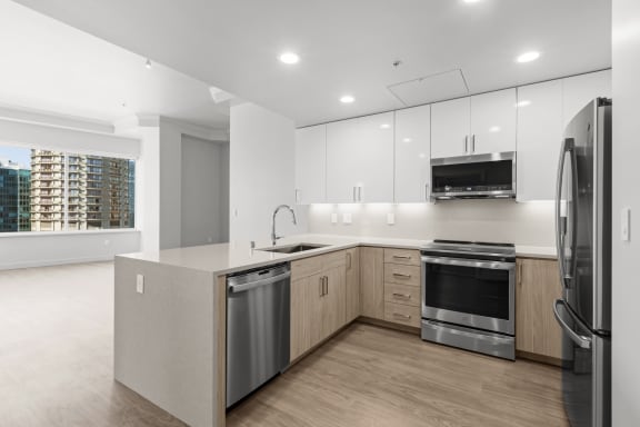 a kitchen with white cabinets and stainless steel appliances