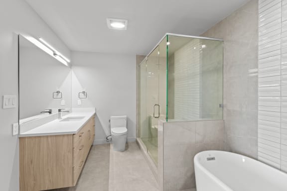 a bathroom with a toilet sink and a shower