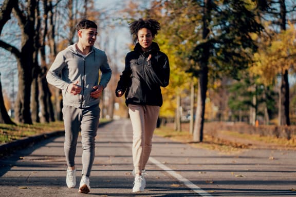Man and Woman Smiling while on Run Together