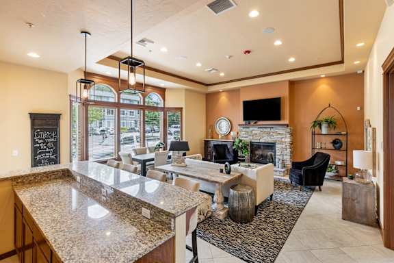 A modern living room with a fireplace and a large TV.