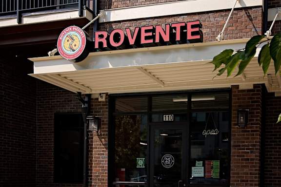 a restaurant with a red and white sign on the front of it