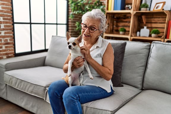 Woman Holding Small Dog Smiling