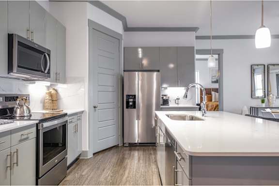 luxury kitchen with stainless steel appliances at Reveal Skyline apartments