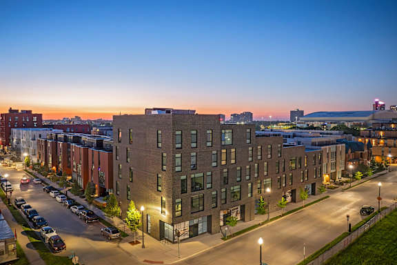 A street view of a residential area with modern apartment buildings.
