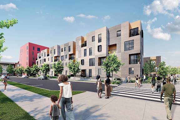 A row of modern buildings with people walking in front.