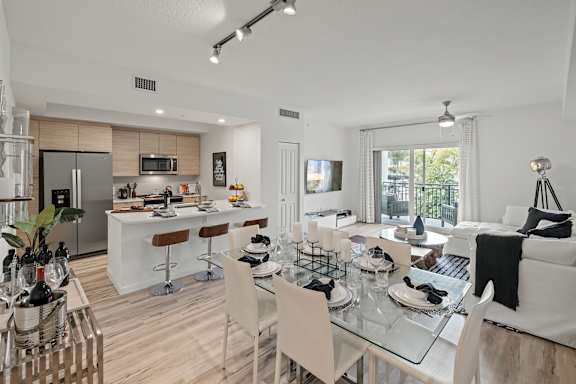 A modern kitchen with a dining table set for four at Altis Blue Lake, Lake Worth, 33467