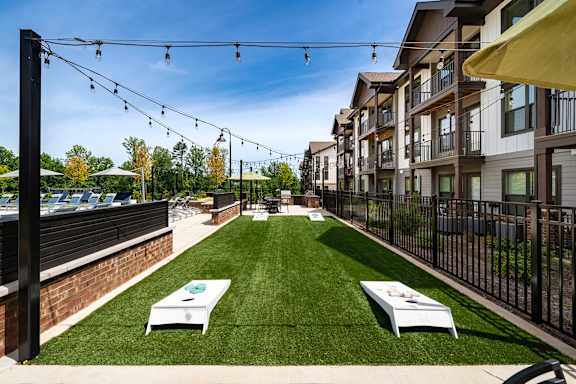 A sunny day at a residential area with a lawn and string lights.