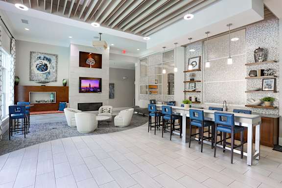 A modern open plan living and dining area with a fireplace.