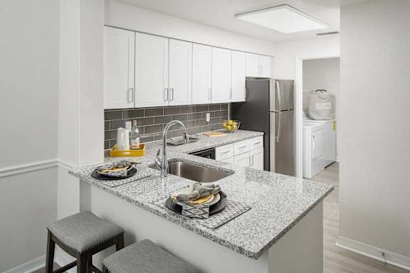 A kitchen with a granite countertop and a sink.