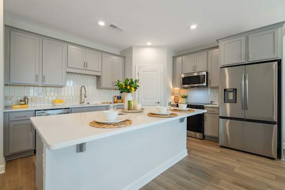 Three floor plans for a house with a garage, kitchen, pantry, family room, and bathroom.