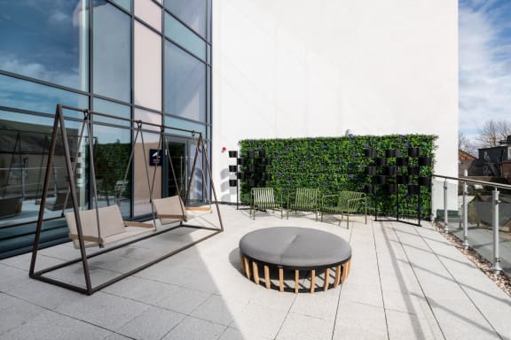 a rendering of a terrace with a couch and tables