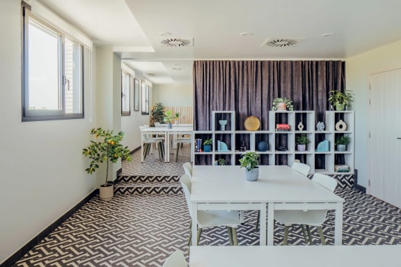 a dining room with a white table and chairs