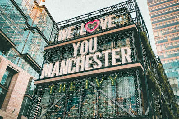 A sign that says "We love you Manchester" is displayed.