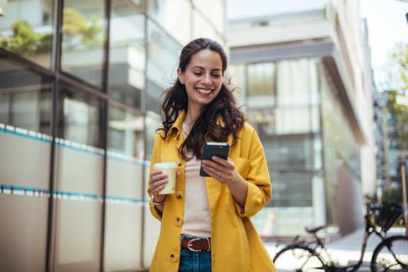 Woman With Coffee And A Phone at The Quarters Apartments, Dock Road