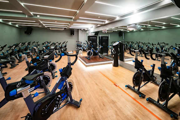 A room full of stationary bikes in a gym.