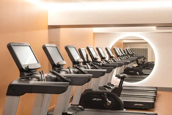 A row of treadmills in a gym.