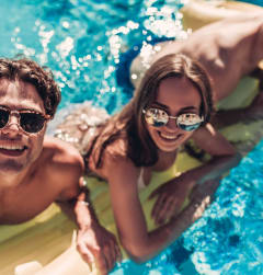 Friends Smiling while Having Fun in Pool Together