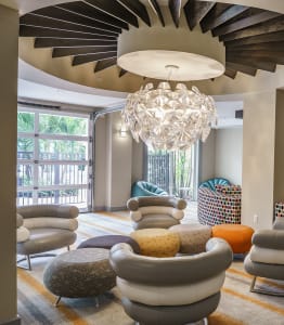 a living room filled with furniture and a large chandelier